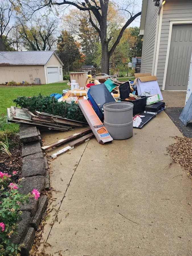 Dumpster being loaded with debris for 3 Yard Dumpster Rental in Ashton-Sandy Spring